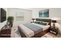 Bedroom with a cozy rug, large window, and stylish staging at 8600 Milestone Dr, Sarasota, FL 34238