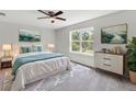Bright bedroom with a ceiling fan, large window, and tastefully decorated with paintings at 9215 Royal River Cir, Parrish, FL 34219