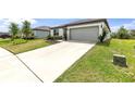 Charming one-story home with an attached two-car garage and well manicured lawn at 9215 Royal River Cir, Parrish, FL 34219