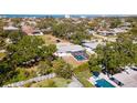 Aerial view of the property showcasing a screened-in pool, lush landscaping, and fenced yard for outdoor entertaining at 923 Dawn St, Venice, FL 34285