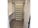 Walk-in closet with custom shelving, ideal for organizing clothes, shoes, and personal items at 10668 Lake Montauk Dr, Riverview, FL 33578
