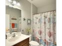 Bathroom with decorative shower curtain, neutral paint, and decorative starfish and seashell elements at 11836 Crawford Parrish Ln, Parrish, FL 34219
