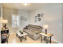 Inviting living room features neutral colors, tile flooring, decorative accents and a large window at 11836 Crawford Parrish Ln, Parrish, FL 34219