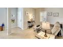 Comfortable living room with neutral paint, tile floors, plantation shutters, and bright natural light at 11836 Crawford Parrish Ln, Parrish, FL 34219