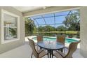 Covered patio with seating area and views of pool and lake at 12041 Thornhill Ct, Lakewood Ranch, FL 34202