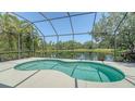 Inviting screened-in pool area overlooking a tranquil lake at 12041 Thornhill Ct, Lakewood Ranch, FL 34202