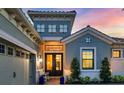 Inviting front entrance featuring double doors, elegant lighting, and manicured landscaping at 15024 Castle Park Ter, Lakewood Ranch, FL 34202