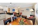 Cozy living room and kitchen featuring modern decor, including granite counters, updated cabinets, and stylish furnishings at 1603 Gulf Dr N # 6, Bradenton Beach, FL 34217