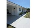 Charming single-story home with a bright white exterior and a covered front entrance at 1750 Gold Ave, Sarasota, FL 34235