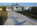 Well maintained front yard with charming single-story home and freshly painted driveway at 1750 Gold Ave, Sarasota, FL 34235
