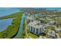 Scenic aerial view of waterfront condos with lush surroundings and beautiful water views at 1932 Harbourside Dr # 217, Longboat Key, FL 34228