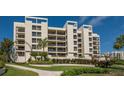 Well-maintained condo building with tropical landscaping and manicured lawn at 1932 Harbourside Dr # 217, Longboat Key, FL 34228