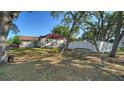 Spacious backyard featuring a wooden swing and a privacy fence at 2385 Tall Oak Ct, Sarasota, FL 34232