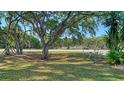 A lovely neighborhood landscape with green space, mature trees, and manicured lawn at 2385 Tall Oak Ct, Sarasota, FL 34232