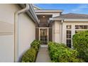 A beautiful entryway with a screened front door and manicured bushes at 3390 Yonge Ave # 41, Sarasota, FL 34235
