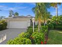A well-kept home with lush, colorful landscaping, a lamp post, and an attached two-car garage at 3390 Yonge Ave # 41, Sarasota, FL 34235
