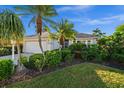 A cozy home with mature landscaping, palm trees, and a well-manicured lawn at 3390 Yonge Ave # 41, Sarasota, FL 34235