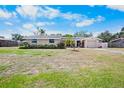 Single-story home with a well-manicured lawn, mature landscaping, and a two-car attached garage at 3612 Wexford Ln, Sarasota, FL 34233