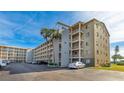 The exterior of a residential building includes multiple balconies and private parking at 3763 Lake Bayshore Dr # 310, Bradenton, FL 34205