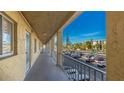An exterior hallway offers a view of the complex, parking, and nearby trees at 3763 Lake Bayshore Dr # 310, Bradenton, FL 34205