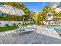 Serene backyard oasis featuring a lounging area, lush landscaping, and tranquil ambiance for outdoor enjoyment at 414 79Th St, Holmes Beach, FL 34217