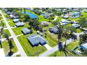 Aerial view of a nice home in a green neighborhood near a tranquil pond at 4404 5Th W Ave, Palmetto, FL 34221
