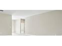 Spacious and well lit hallway with neutral colored walls and flooring at 5454 Rhapsody Ave, North Port, FL 34288