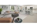 Bright living room flows into the kitchen with plenty of natural light, modern furnishings, and decor at 5454 Rhapsody Ave, North Port, FL 34288