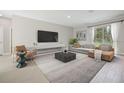 Comfortable living room area features a large tv and modern furnishings at 5454 Rhapsody Ave, North Port, FL 34288
