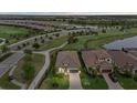 Aerial view of a well-maintained neighborhood with lush landscaping, golf course, and a lake in a beautiful community at 5811 Brandon Run, Bradenton, FL 34211