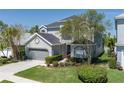 Charming two-story home boasts a well-maintained lawn and an attached two-car garage at 6210 Laurel Creek Trl, Ellenton, FL 34222