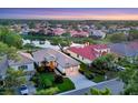Beautiful aerial view of a waterfront community featuring lush landscaping and serene lake views at 6458 Tailfeather Way, Bradenton, FL 34203
