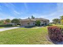 Charming home with lush landscaping, green lawn, and a tiled roof at 7116 Drewrys Blf, Bradenton, FL 34203