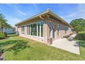 Home featuring a well-manicured lawn and rear patio space at 7116 Drewrys Blf, Bradenton, FL 34203
