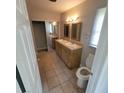 Bright bathroom featuring a double sink vanity and tile flooring at 835 Indiana Ln, Sarasota, FL 34234