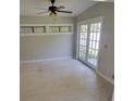Bright living room featuring french doors, white painted hardwood floors and neutral walls at 835 Indiana Ln, Sarasota, FL 34234