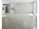 Expansive living area featuring neutral walls and tile flooring, offering a blank canvas for personalization at 110 Pine Ave, Osprey, FL 34229