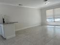Sunlit living space showcases modern flooring and a convenient breakfast bar, ideal for entertaining and daily living at 110 Pine Ave, Osprey, FL 34229