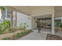 Inviting condo entrance with well-manicured landscaping, tiled walkway, and secure entry at 1104 Benjamin Franklin Dr # 519, Sarasota, FL 34236