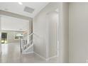 Bright hallway leading to staircase and living area with tile flooring, neutral paint, and ample space at 11420 Golden Bay Pl, Bradenton, FL 34211