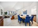 Bright living and dining area with tile flooring and sliding glass doors to a spacious balcony at 1240 Dolphin Bay Way # 304, Siesta Key, FL 34242