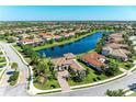 Expansive aerial view of homes surrounding a lake, showing the neighborhood's layout and community feel at 13107 Bridgeport Xing, Lakewood Ranch, FL 34211