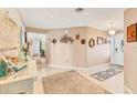 Neutral foyer with wall decor and a view into the rest of the house at 1320 Magellan Dr, Sarasota, FL 34243