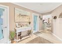 Foyer featuring neutral colors, a beach themed painting and decor, and wood look floors at 1320 Magellan Dr, Sarasota, FL 34243