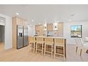 Modern kitchen features a large island with seating, stainless steel appliances, and stylish wood cabinets at 1406 N Riverhills Dr, Temple Terrace, FL 33617
