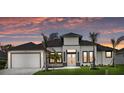 Inviting single-story home with manicured lawn, striking modern architectural details, and a two-car garage at 193 Rotonda N Blvd, Rotonda West, FL 33947