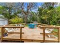 Outdoor entertaining space with a wooden deck and charming backyard setting at 2225 Alice Rd, Sarasota, FL 34231