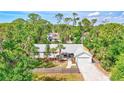 Aerial view of a charming single-story home surrounded by mature trees and greenery at 2425 21St St # B, Sarasota, FL 34234