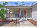 Inviting front porch with cozy seating and well-maintained landscaping at 2425 21St St # B, Sarasota, FL 34234