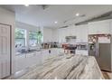 Bright modern kitchen featuring white cabinets, stainless steel appliances, and granite countertops at 2425 21St St # B, Sarasota, FL 34234